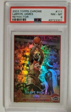 2003-04 Topps Chrome #111 LeBron James Refractor rookie card in a PSA 8 holder: James driving to the basket in the Cavaliers uniform, the chrome surface showing the Refractor's rainbow sheen